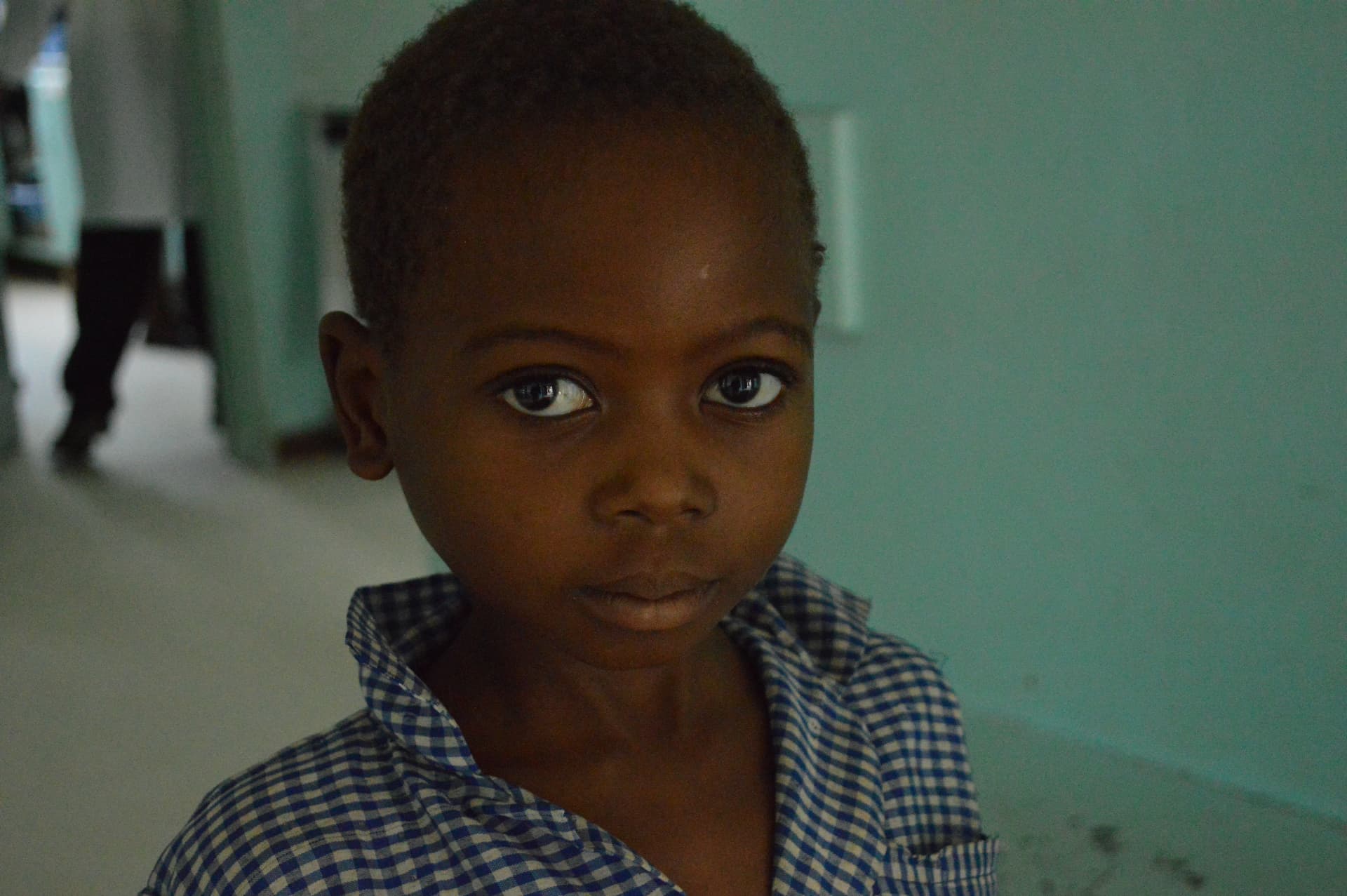 A young boy in a checked school shirt
