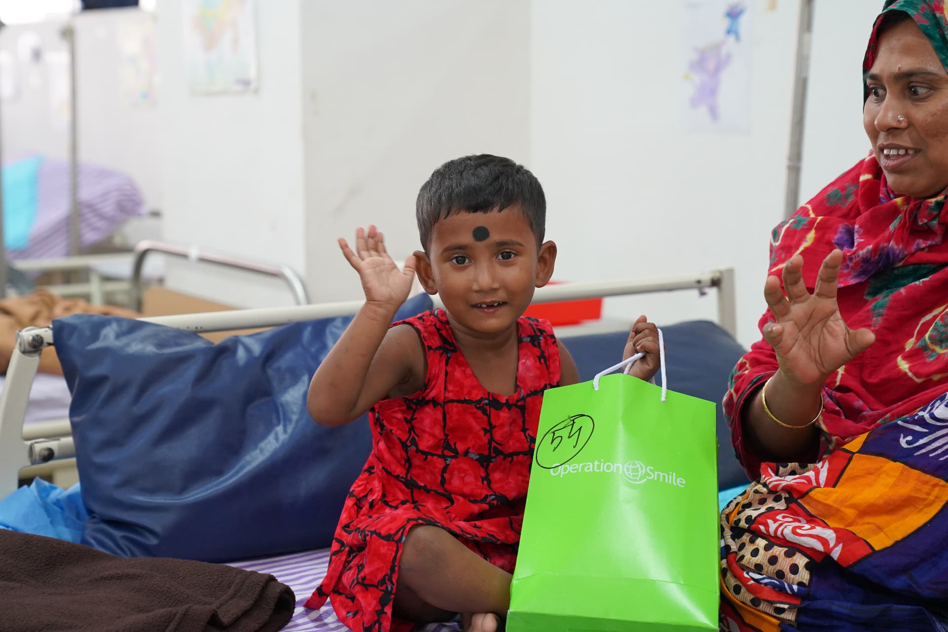 A child and her mother receiving care at a hospital